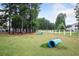 Community dog park featuring grassy areas, agility equipment, and surrounding trees at 262 Great Lawn Dr, Summerville, SC 29486