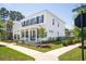 Charming two-story white home with a welcoming front porch, rocking chairs, and manicured landscaping at 262 Great Lawn Dr, Summerville, SC 29486