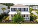 Inviting two-story home with a covered porch and classic black shutters in a peaceful neighborhood setting at 262 Great Lawn Dr, Summerville, SC 29486