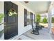 Relaxing front porch with rocking chairs, complemented by a decorative wreath on the front door at 262 Great Lawn Dr, Summerville, SC 29486
