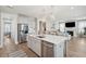 Bright, open-concept kitchen and living space with stainless steel appliances and a cozy fireplace at 262 Great Lawn Dr, Summerville, SC 29486