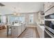 Bright kitchen featuring a large island, pendant lights, stainless appliances, and backyard view at 262 Great Lawn Dr, Summerville, SC 29486