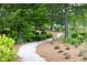 Landscaped walking path through the community with lush greenery and mature trees at 262 Great Lawn Dr, Summerville, SC 29486