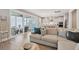 Bright, open living room with sliding glass doors and a view to modern kitchen at 262 Great Lawn Dr, Summerville, SC 29486