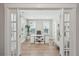 Bright home office featuring wood floors, a modern white desk, and windows offering plenty of natural light at 262 Great Lawn Dr, Summerville, SC 29486