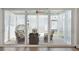 Covered porch with large glass doors and windows, wicker chairs and ceiling fan at 262 Great Lawn Dr, Summerville, SC 29486