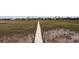 Sprawling marsh landscape with a wooden boardwalk leading to a neighborhood of luxurious waterfront homes at 2705 Parkers Landing Rd, Mount Pleasant, SC 29466