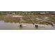 An aerial view of a waterfront community featuring homes with private boat docks on a marsh at 2705 Parkers Landing Rd, Mount Pleasant, SC 29466