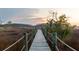 Scenic boardwalk at sunset surrounded by lush marsh, offering a tranquil and picturesque waterfront experience at 2705 Parkers Landing Rd, Mount Pleasant, SC 29466