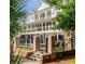 A beautiful home with multiple balconies overlooks a landscaped yard, offering elegant outdoor living spaces at 2705 Parkers Landing Rd, Mount Pleasant, SC 29466