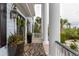 Charming front porch featuring columns, black lanterns, a welcome mat, and potted flowers at 2705 Parkers Landing Rd, Mount Pleasant, SC 29466