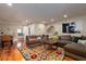 Comfortable living room with foosball table and a brightly patterned rug over hardwood floors at 2705 Parkers Landing Rd, Mount Pleasant, SC 29466