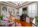 A cozy office featuring hardwood floors, a built-in desk, and natural light from plantation shutters at 2705 Parkers Landing Rd, Mount Pleasant, SC 29466