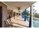 A luxurious outdoor space features a covered patio with ceiling fans and a view of the pool at 2705 Parkers Landing Rd, Mount Pleasant, SC 29466