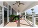 Covered porch with comfortable wicker seating, palm trees, and ceiling fans at 2705 Parkers Landing Rd, Mount Pleasant, SC 29466