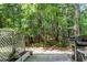 Enjoy this shady backyard featuring mature trees, privacy, a grill, and a concrete patio at 271 Jackson St, Goose Creek, SC 29445