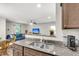 Modern kitchen view into living area; granite countertops & stainless sink at 271 Jackson St, Goose Creek, SC 29445