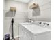 Bright laundry room with a washer and dryer with wire shelving above at 271 Jackson St, Goose Creek, SC 29445