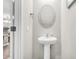 Powder room featuring a pedestal sink and a decorative mirror at 271 Jackson St, Goose Creek, SC 29445