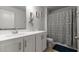 Bright bathroom featuring a white vanity, decorative shower curtain, and neutral tiling at 2746 Sunrose Ln, Johns Island, SC 29455