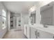 Bright bathroom featuring a double vanity, and a glass-enclosed shower at 2746 Sunrose Ln, Johns Island, SC 29455
