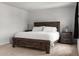 Comfortable bedroom with a dark wood bed frame and neutral carpet at 2746 Sunrose Ln, Johns Island, SC 29455