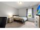 Bedroom with wood flooring, a bed, and a window, offering a tranquil retreat at 2746 Sunrose Ln, Johns Island, SC 29455