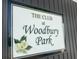 The Club at Woodbury Park sign with a black frame and magnolia, near a black building at 2746 Sunrose Ln, Johns Island, SC 29455
