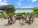 Relax and enjoy the outdoors with this brick fire pit surrounded by chairs and overlooking the lake at 2746 Sunrose Ln, Johns Island, SC 29455