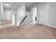 Carpeted hallway with white walls, white trim, and a wooden handrail, leading to multiple rooms at 2746 Sunrose Ln, Johns Island, SC 29455