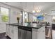 Granite kitchen island with pendant lights and a stainless steel dishwasher at 2746 Sunrose Ln, Johns Island, SC 29455