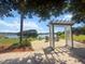 Scenic lake view with pergola and seating area, ideal for enjoying peaceful surroundings at 2746 Sunrose Ln, Johns Island, SC 29455