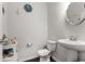 Charming powder room with dark wood floors, pedestal sink, and decorative accents offering a stylish touch at 2746 Sunrose Ln, Johns Island, SC 29455