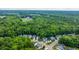 An aerial view of a residential area surrounded by lush forest, with a water tower in the distance at 3031 Ellington Dr, Summerville, SC 29485