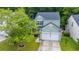 A charming two-story home is nestled among lush trees, with a driveway and well-kept lawn at 3031 Ellington Dr, Summerville, SC 29485