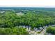An aerial view of a residential area surrounded by lush forest, with a water tower in the distance at 3031 Ellington Dr, Summerville, SC 29485