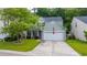 Classic two-story home featuring a two-car garage, a green lawn, and an American flag at 3031 Ellington Dr, Summerville, SC 29485