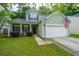 Charming two-story home with a well-manicured lawn and inviting front porch with the USA flag at 3031 Ellington Dr, Summerville, SC 29485