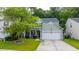 Charming two-story home with an American flag, well-maintained lawn, and a two-car garage at 3031 Ellington Dr, Summerville, SC 29485