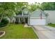 Charming two-story home with a well-manicured lawn, American flag, and a two-car garage at 3031 Ellington Dr, Summerville, SC 29485