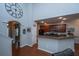 Spacious kitchen featuring a breakfast bar, dark wood cabinets, stainless steel appliances, and an adjacent arched doorway at 3031 Ellington Dr, Summerville, SC 29485