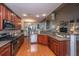 Contemporary kitchen with stainless steel appliances, granite countertops, and dark cabinetry flowing into the dining room at 3031 Ellington Dr, Summerville, SC 29485