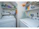 Functional laundry room with washer, dryer, and ample shelving for storage at 3031 Ellington Dr, Summerville, SC 29485