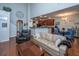 Bright open-concept living room with modern furnishings, hardwood floors, and seamless flow into the kitchen and dining area at 3031 Ellington Dr, Summerville, SC 29485