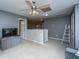 Open loft area with neutral carpet, gray walls, and a decorative ladder; ceiling fan included at 3031 Ellington Dr, Summerville, SC 29485