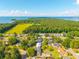 Aerial view of a neighborhood near the lake featuring single-Gathering homes and lush trees at 305 Whitewood Ct, Moncks Corner, SC 29461