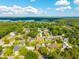 Overhead view of a residential area with lush trees, pools, and a blue lake at 305 Whitewood Ct, Moncks Corner, SC 29461