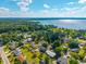 Aerial view of a neighborhood with lake views, lush trees, and clear blue skies at 305 Whitewood Ct, Moncks Corner, SC 29461