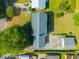Overhead aerial view of the house showing its layout, roof, driveway, and detached garage at 305 Whitewood Ct, Moncks Corner, SC 29461