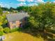 Aerial view of the brick home showcasing its roof, lawn, and mature trees at 305 Whitewood Ct, Moncks Corner, SC 29461